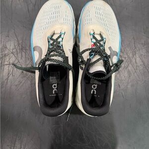 On Running Cream and Black Athletic Shoes